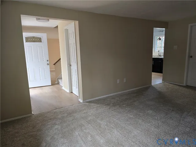 a view of empty room with a fireplace