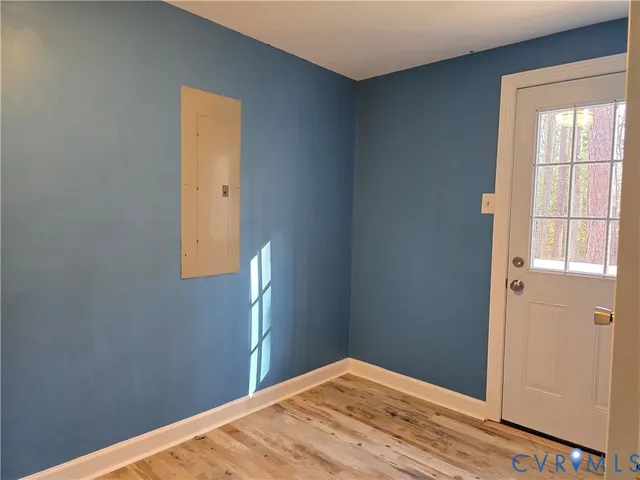 a view of a hallway with wooden floor