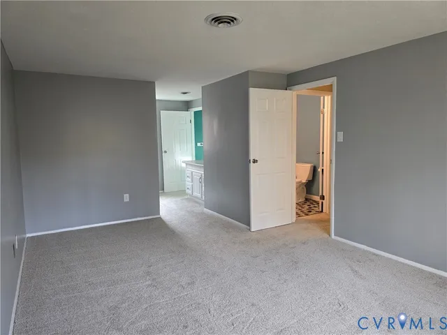 a view of an empty room and closet area