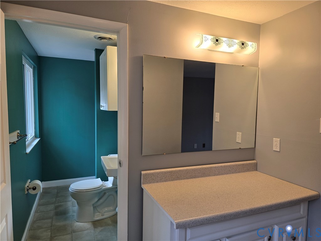 4600 Painted Post Lane Midlothian, VA 23112 - Photo 28 of 44 a bathroom with a sink a toilet and mirror