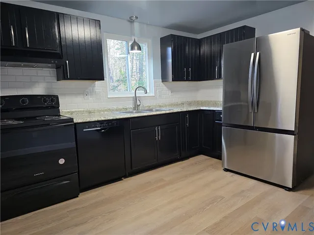 a kitchen with granite countertop stainless steel appliances and wooden cabinets