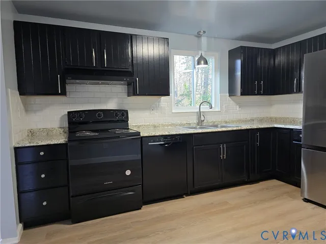 a kitchen with granite countertop stainless steel appliances and cabinets counter space