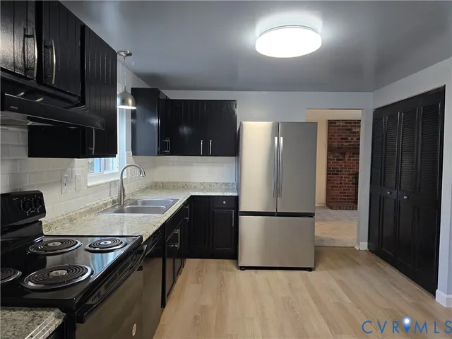 a kitchen with a refrigerator and a sink
