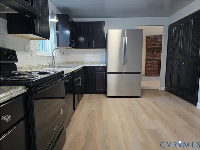 a kitchen with a sink a stove and refrigerator