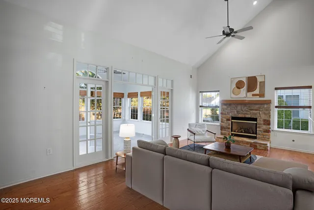 a living room with furniture a fireplace and a large window