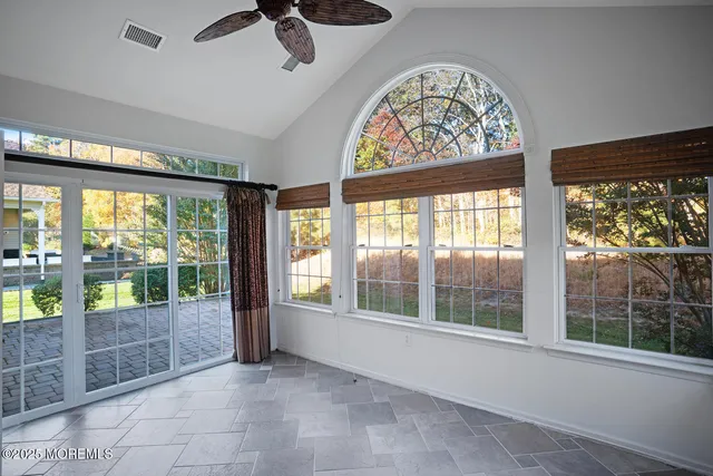 a view of room with furniture and large windows