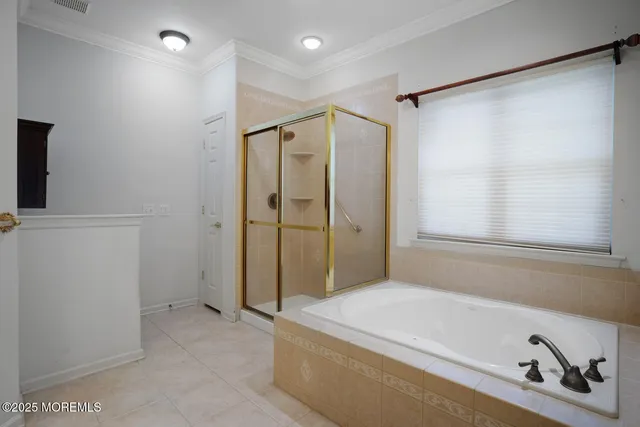 a bathroom with a tub and a shower