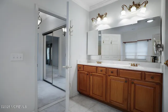 a spacious bathroom with a double vanity sink mirror and shower