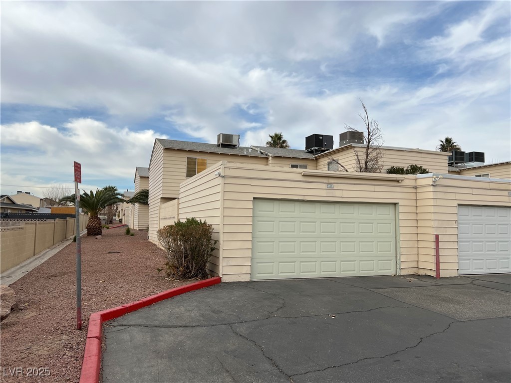 4715 Mill Valley Drive Las Vegas, NV 89120 - Photo 3 of 4 Garage featuring fence, central AC, and aphalt driveway