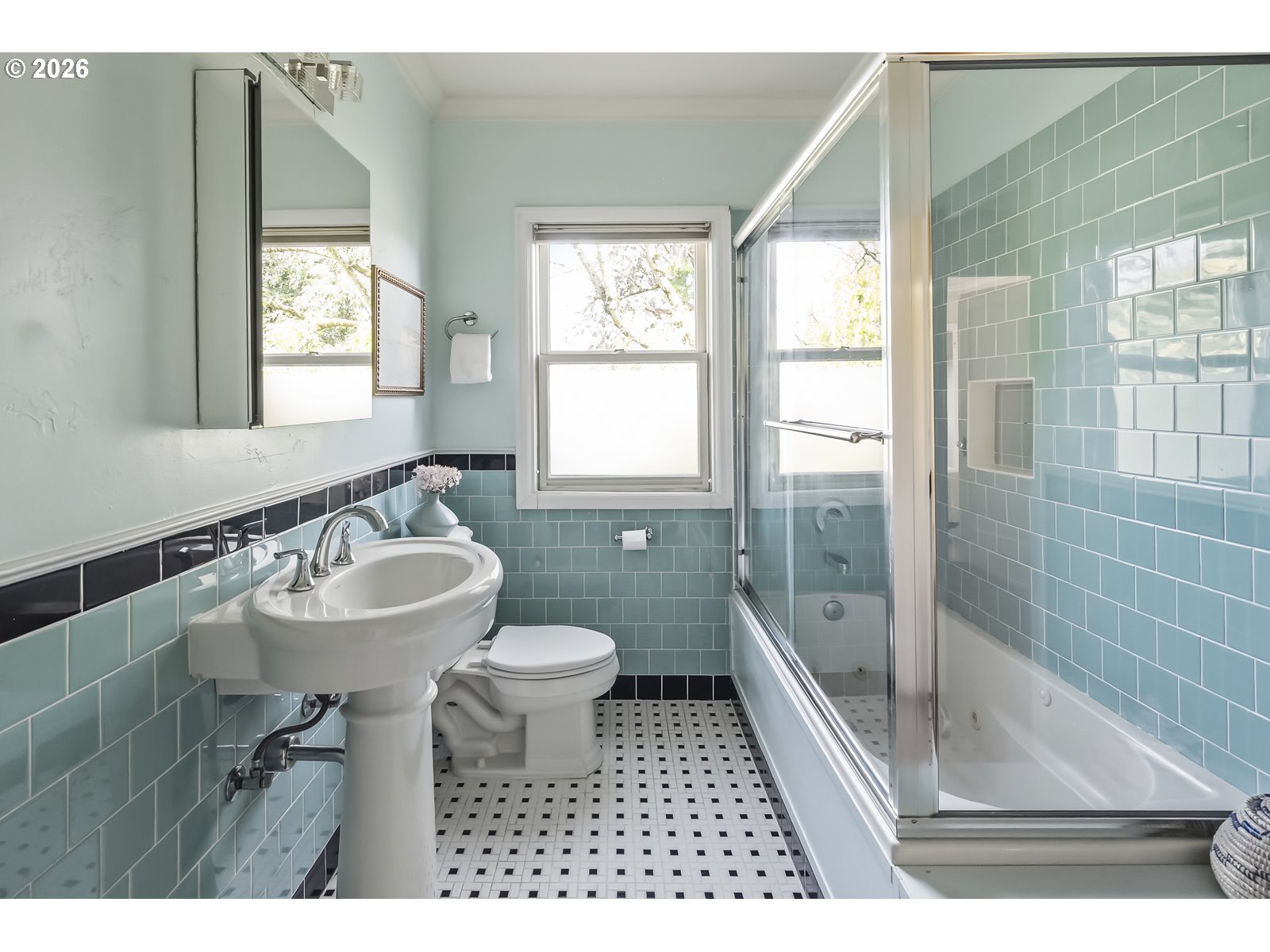 4353 Northeast Halsey Street, Unit 4 Portland, OR 97213 - Photo 11 of 24 a bathroom with a sink a toilet a mirror and shower
