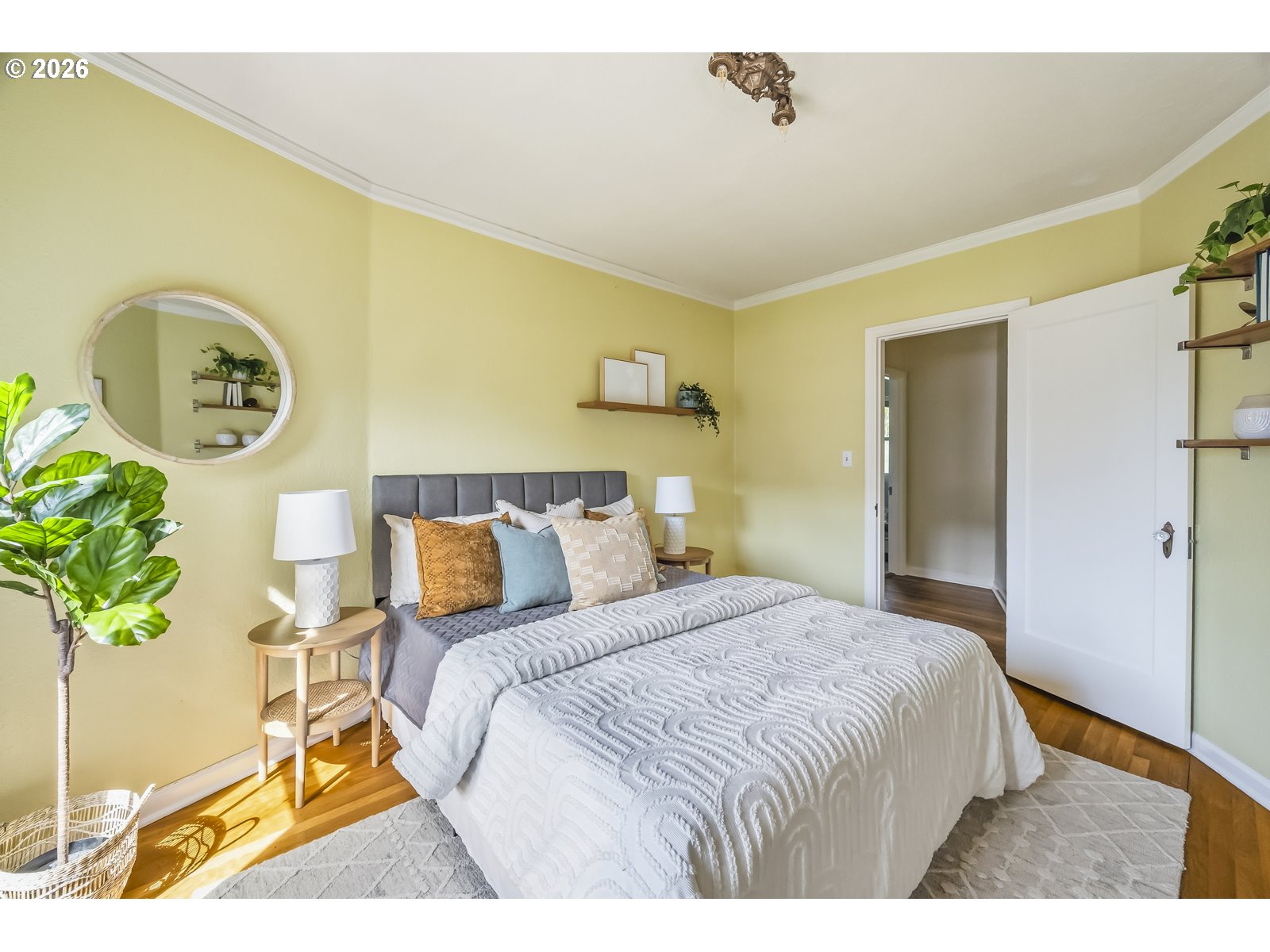 4353 Northeast Halsey Street, Unit 4 Portland, OR 97213 - Photo 13 of 24 a bedroom with a bed and a painting on the wall
