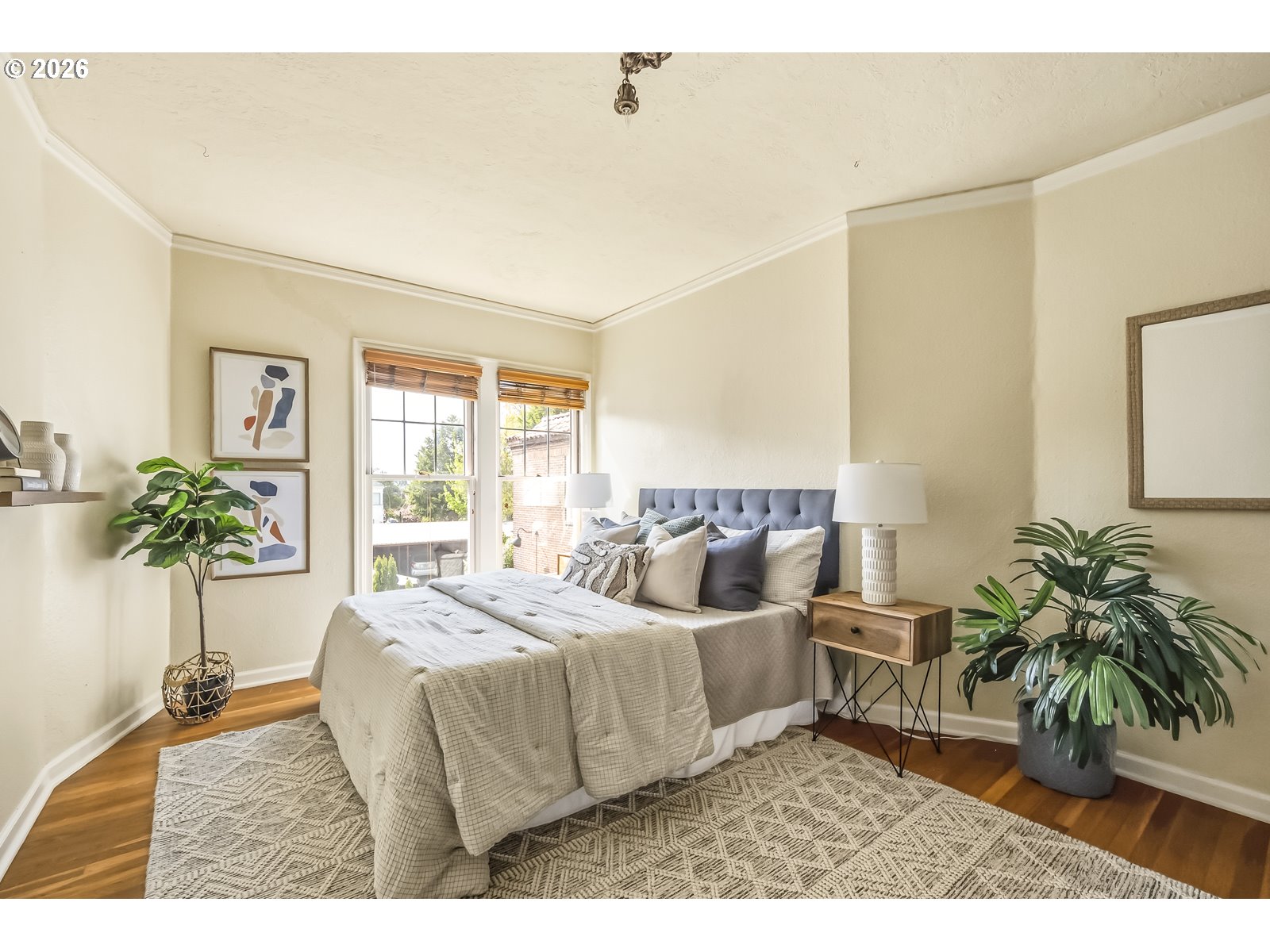 4353 Northeast Halsey Street, Unit 4 Portland, OR 97213 - Photo 14 of 24 a bedroom with bed and a potted plant
