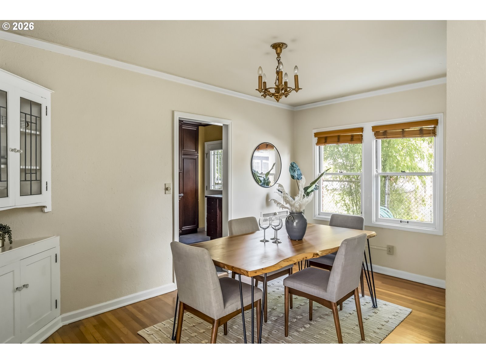 4353 Northeast Halsey Street, Unit 4 Portland, OR 97213 - Photo 4 of 24 a view of a dining room with furniture a chandelier and a window