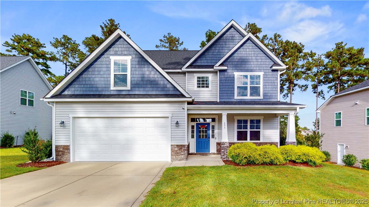 493 Timber Skip Drive Spring Lake, NC 28390 - Photo 1 of 33 a front view of a house with a yard and garage