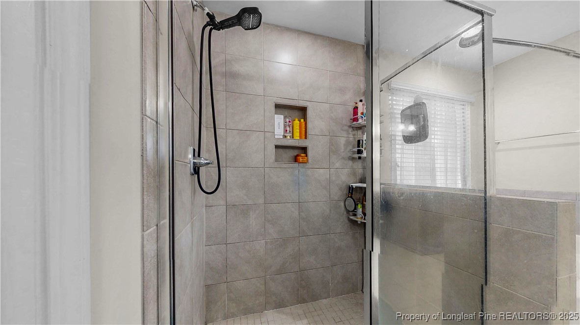 493 Timber Skip Drive Spring Lake, NC 28390 - Photo 19 of 33 a bathroom with a shower