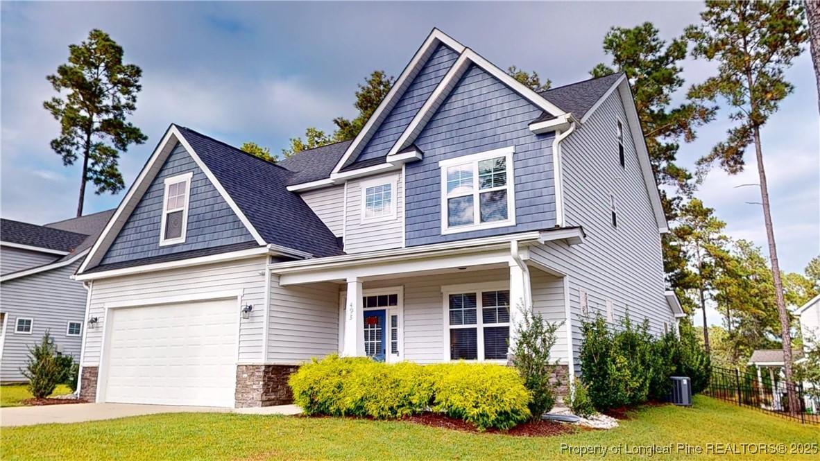 493 Timber Skip Drive Spring Lake, NC 28390 - Photo 2 of 33 a view of a house with a yard and plants
