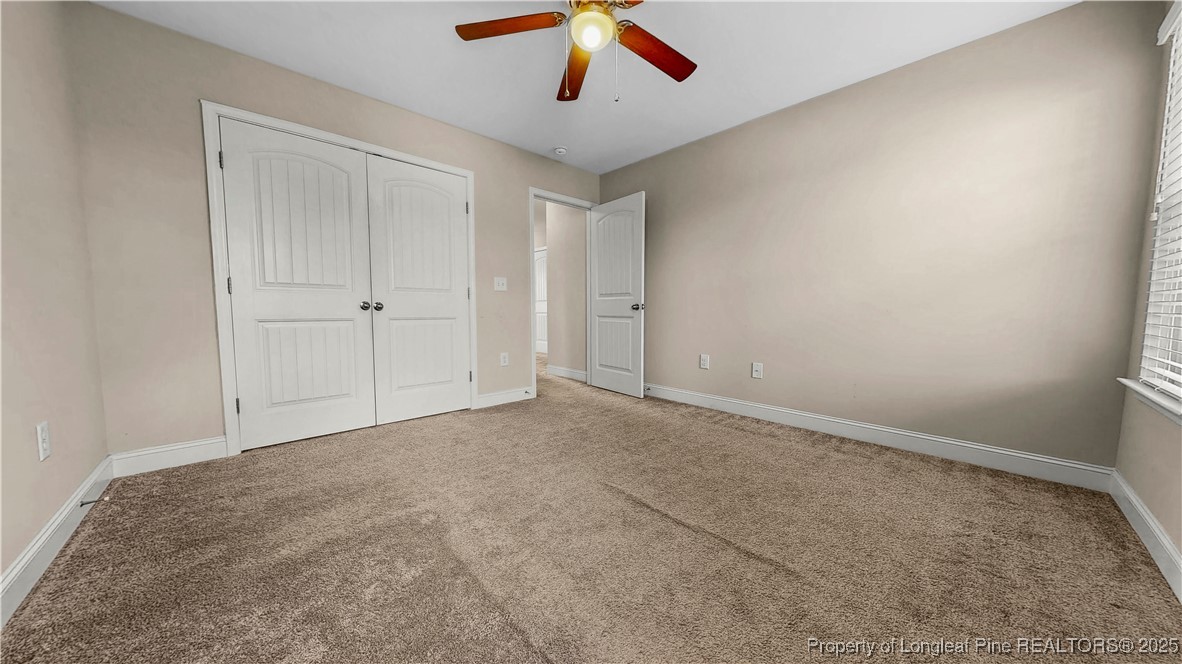 493 Timber Skip Drive Spring Lake, NC 28390 - Photo 25 of 33 a view of an empty room and chandelier fan
