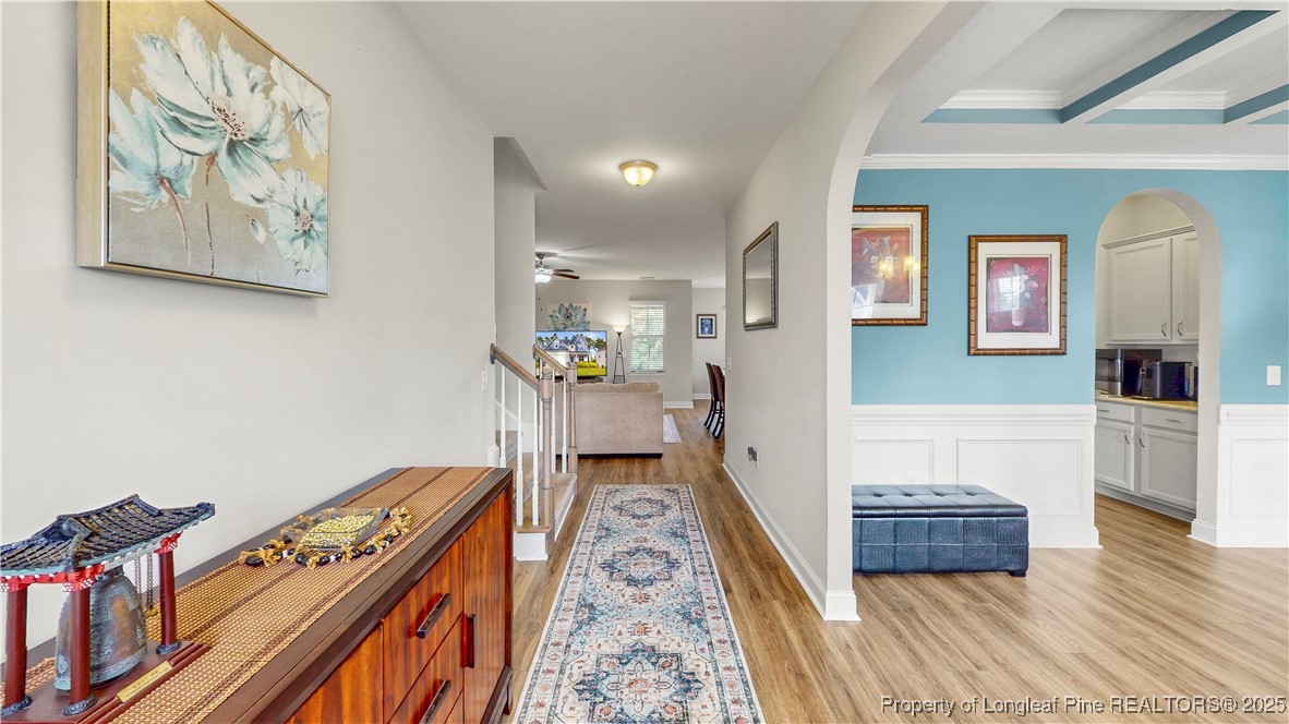 493 Timber Skip Drive Spring Lake, NC 28390 - Photo 3 of 33 a hallway with painting on the wall and a rug