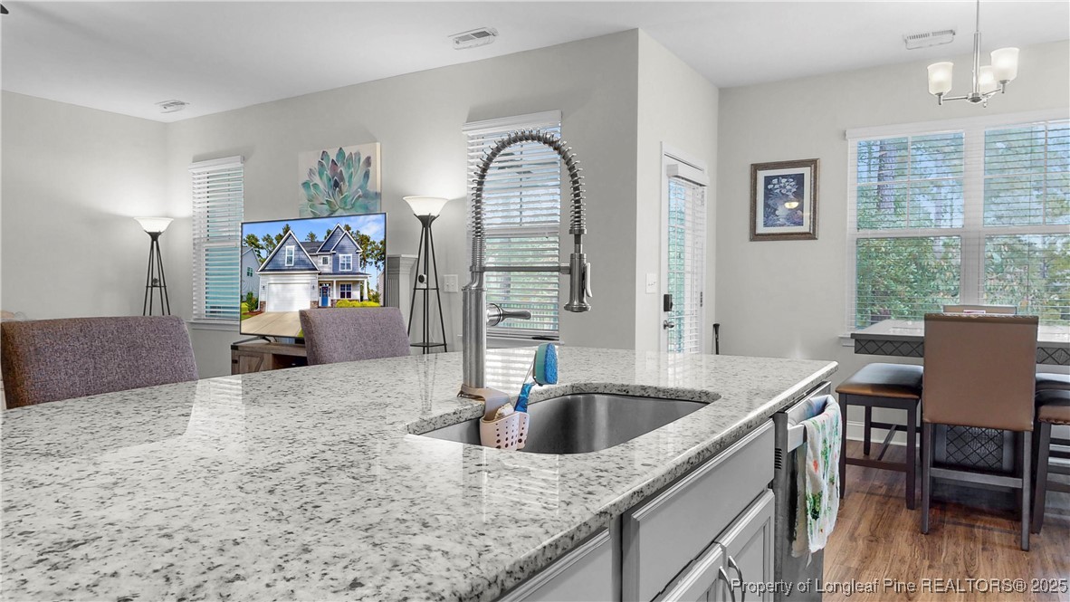 493 Timber Skip Drive Spring Lake, NC 28390 - Photo 10 of 33 a kitchen that has a cabinets and a sink