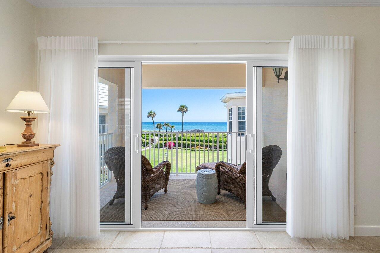 5900 Old Ocean Boulevard, Unit C6 Ocean Ridge, FL 33435 - Photo 13 of 21 a living room with furniture and a floor to ceiling window