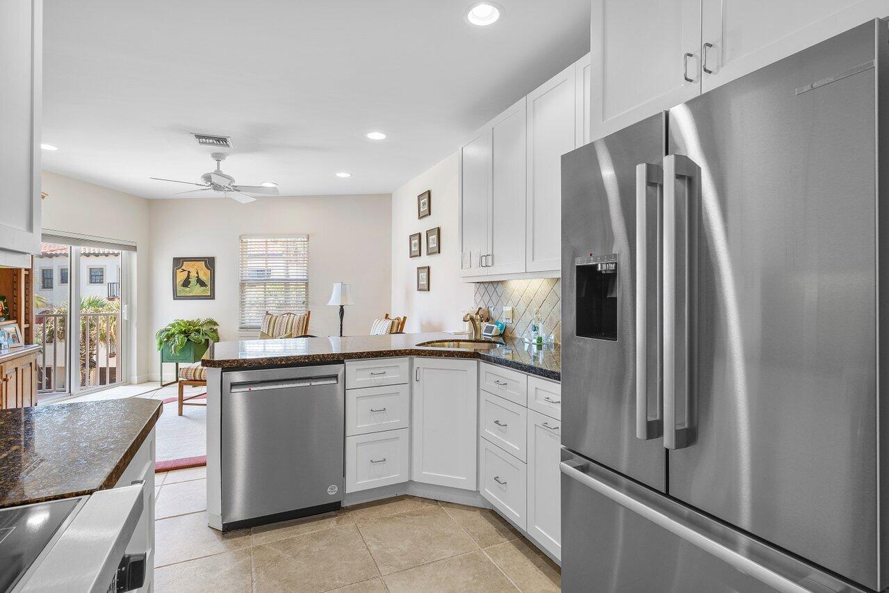 5900 Old Ocean Boulevard, Unit C6 Ocean Ridge, FL 33435 - Photo 19 of 21 a kitchen with stainless steel appliances a refrigerator sink and cabinets