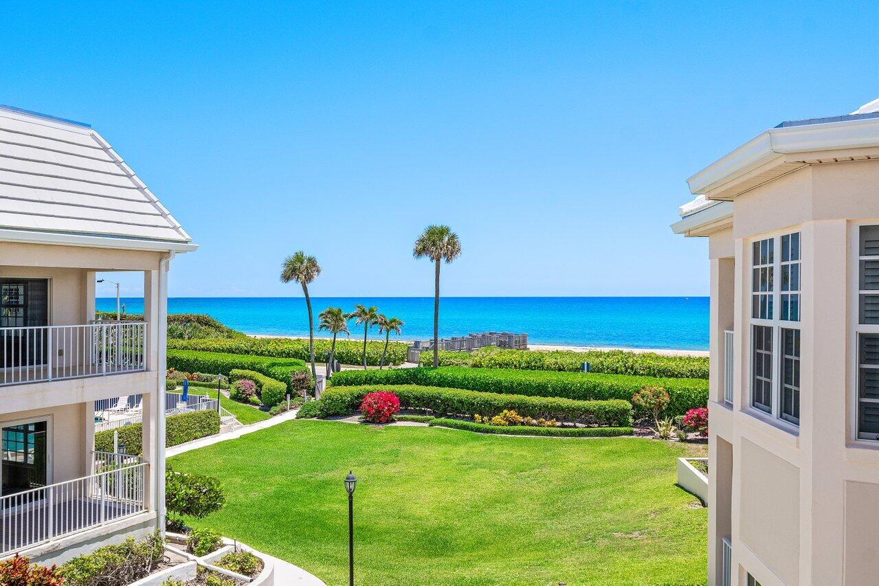 5900 Old Ocean Boulevard, Unit C6 Ocean Ridge, FL 33435 - Photo 6 of 21 a view of a big house with a big yard and potted plants