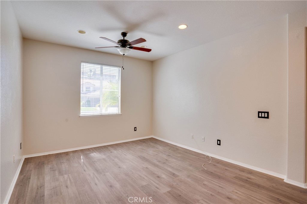 33440 Barrington Drive Temecula, CA 92592 - Photo 19 of 72 a view of an empty room with wooden floor and a window