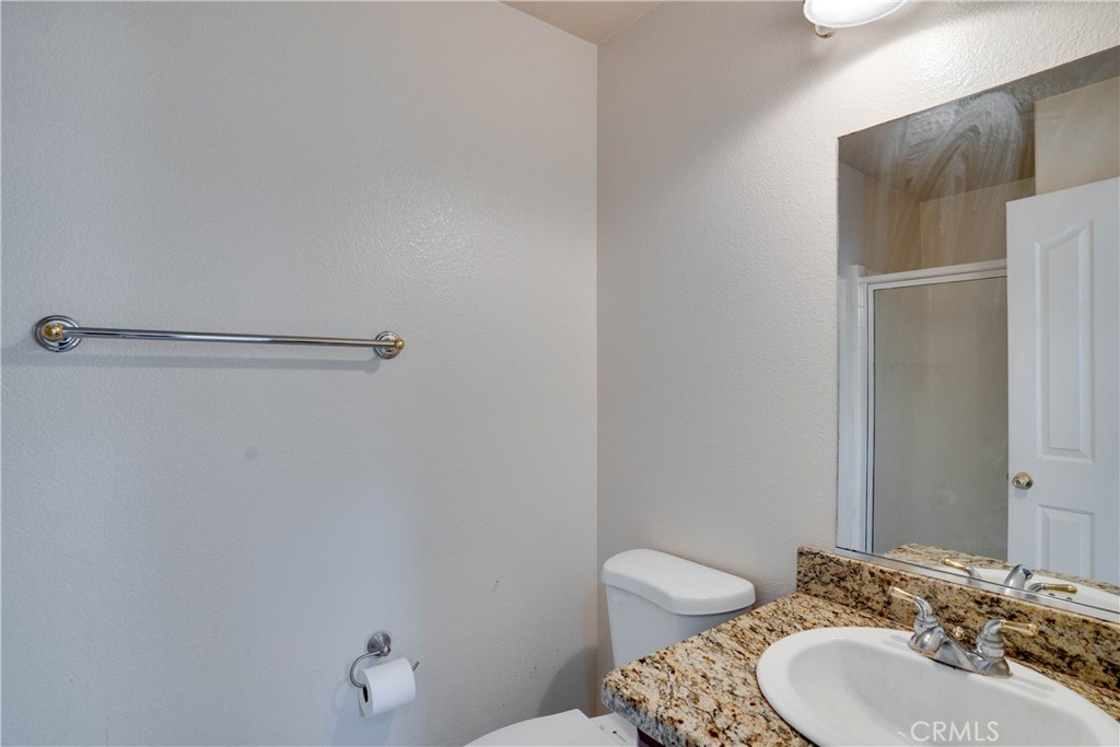 33440 Barrington Drive Temecula, CA 92592 - Photo 21 of 72 a bathroom with a sink toilet and a mirror