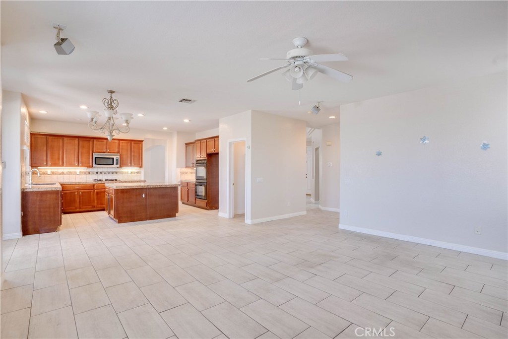 33440 Barrington Drive Temecula, CA 92592 - Photo 29 of 72 a large white kitchen with a sink and cabinets