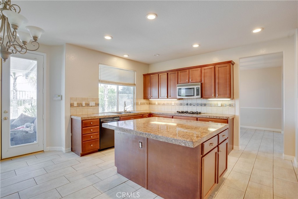 33440 Barrington Drive Temecula, CA 92592 - Photo 31 of 72 a kitchen with stainless steel appliances granite countertop a stove and a sink
