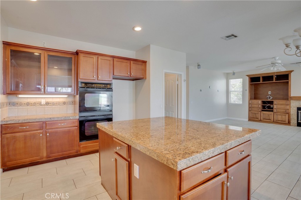 33440 Barrington Drive Temecula, CA 92592 - Photo 33 of 72 a kitchen with stainless steel appliances granite countertop a sink refrigerator and cabinets