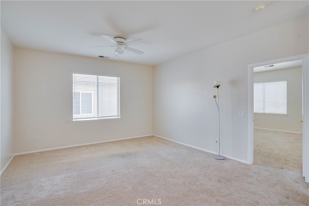 33440 Barrington Drive Temecula, CA 92592 - Photo 42 of 72 an empty room with a ceiling fan and a window