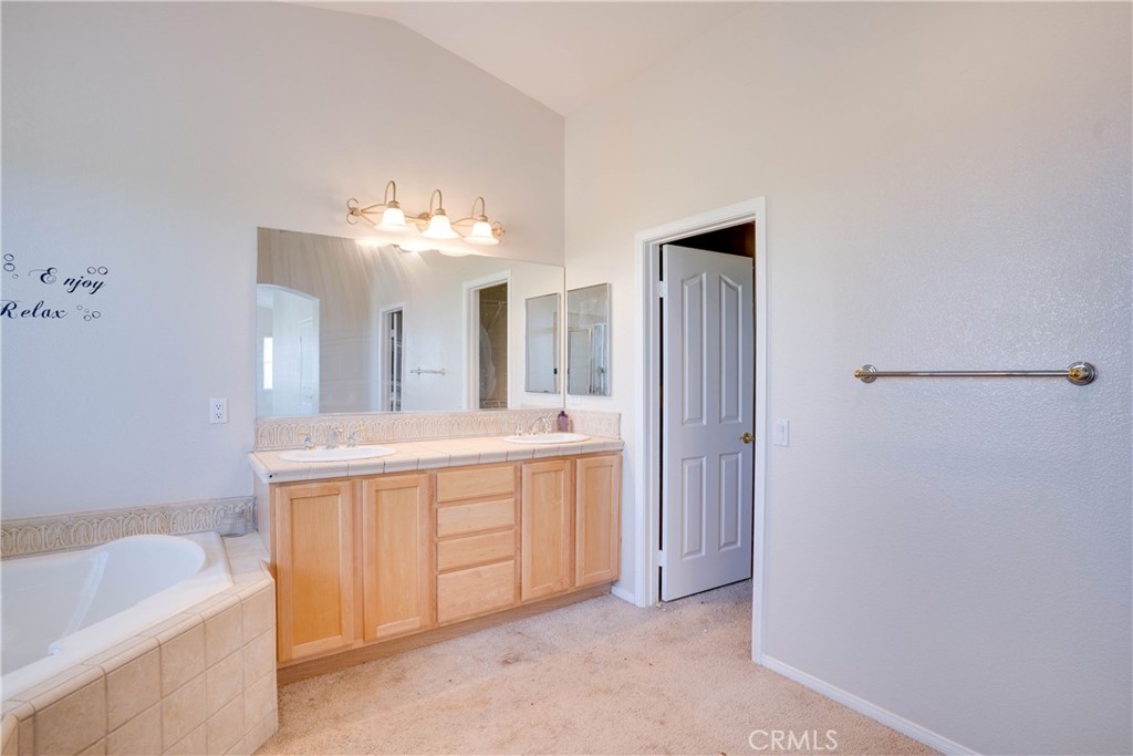 33440 Barrington Drive Temecula, CA 92592 - Photo 50 of 72 a spacious bathroom with a bathtub sink and mirror