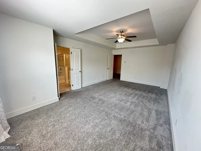 a view of an empty room with a ceiling fan