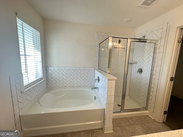 a bathroom with a bathtub and a shower