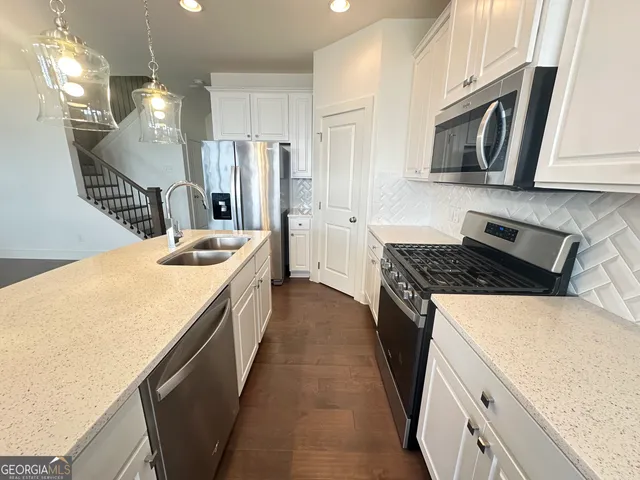 a kitchen with a stove and a sink