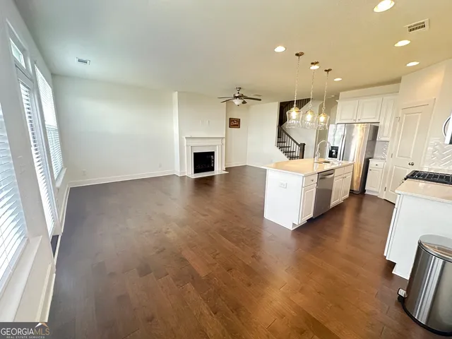 a view of kitchen with furniture and wooden floor