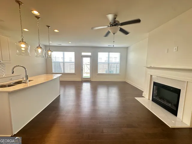 a large kitchen with cabinets a sink and appliances