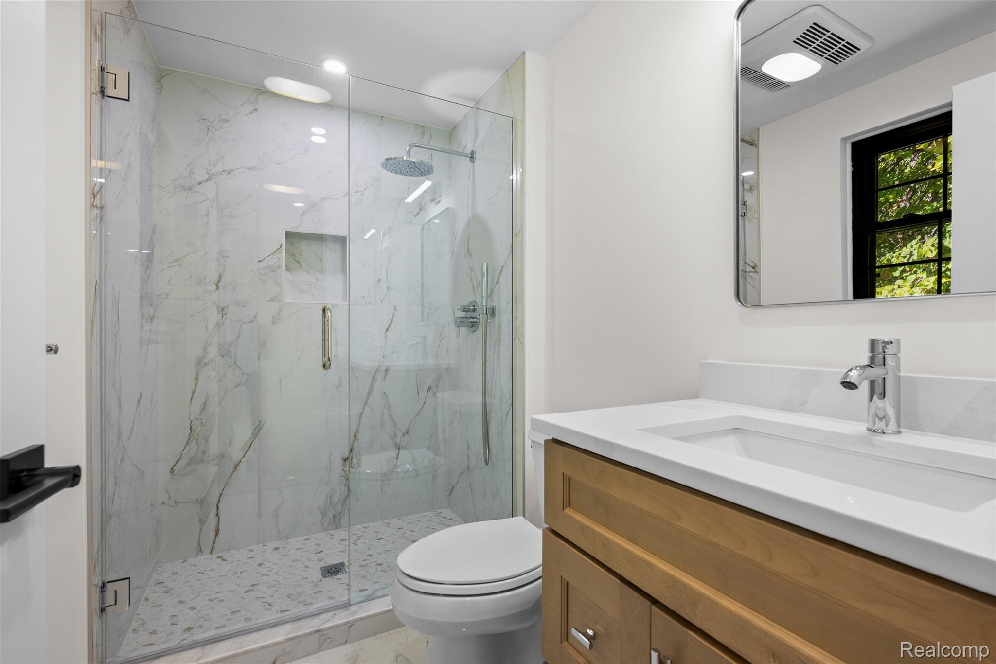 1830 Streamedge Court Rochester, MI 48309 - Photo 21 of 33 Walk-in shower with clear glass enclosure and marble-style tile