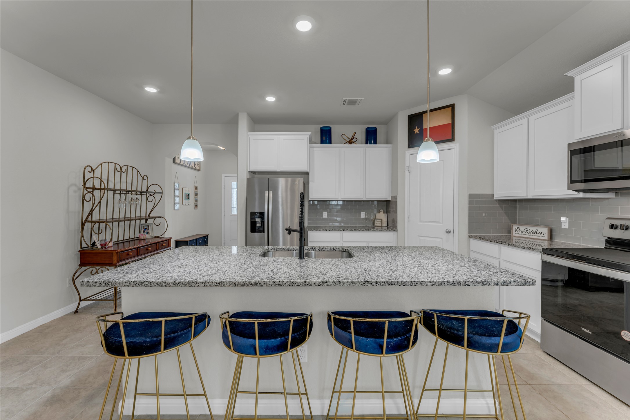 132 Cinnamon Loop Burnet, TX 78611 - Photo 7 of 27 Kitchen island featuring a granite countertop with integrated sink and pendant lighting