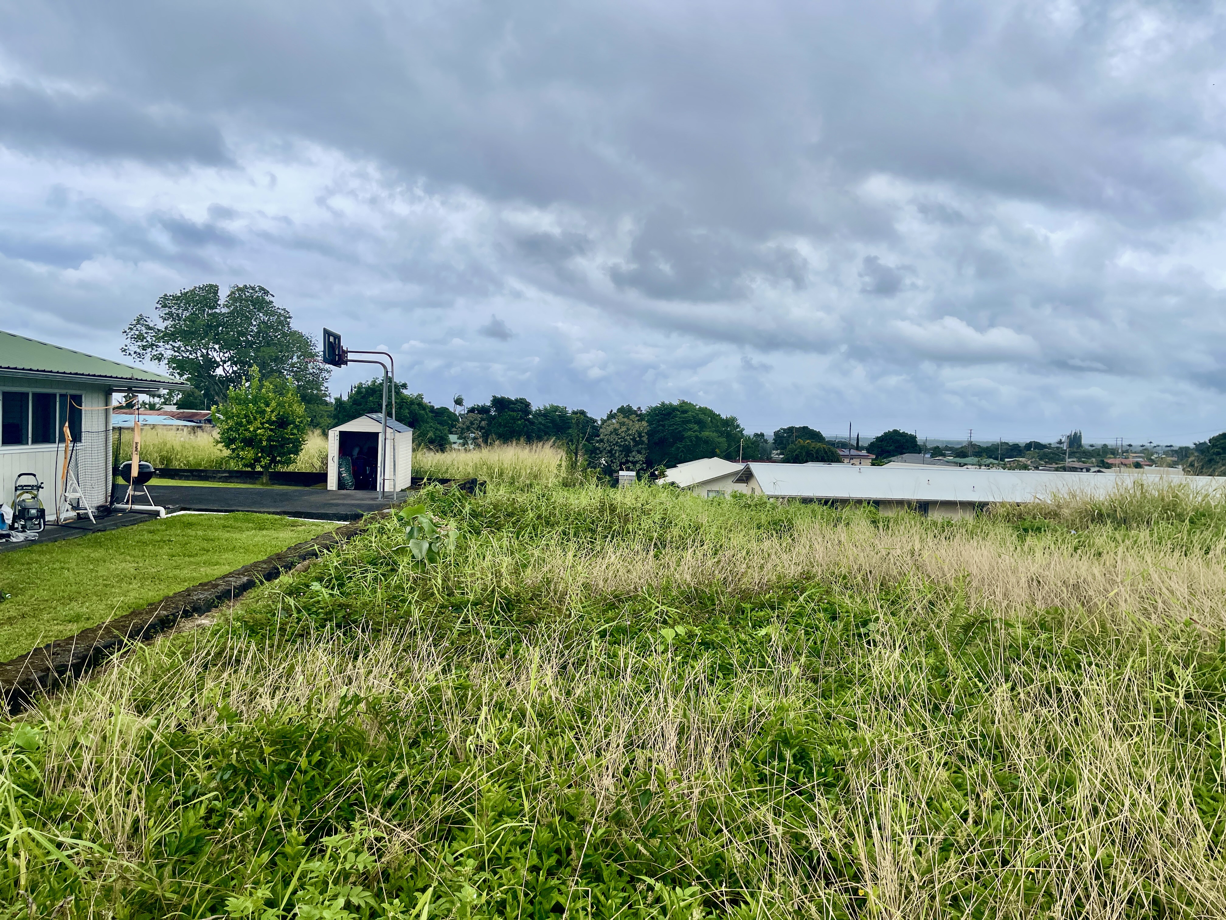 6 Lot Hilo, HI 96720 - Photo 8 of 18 a view of a lake with a house in the background