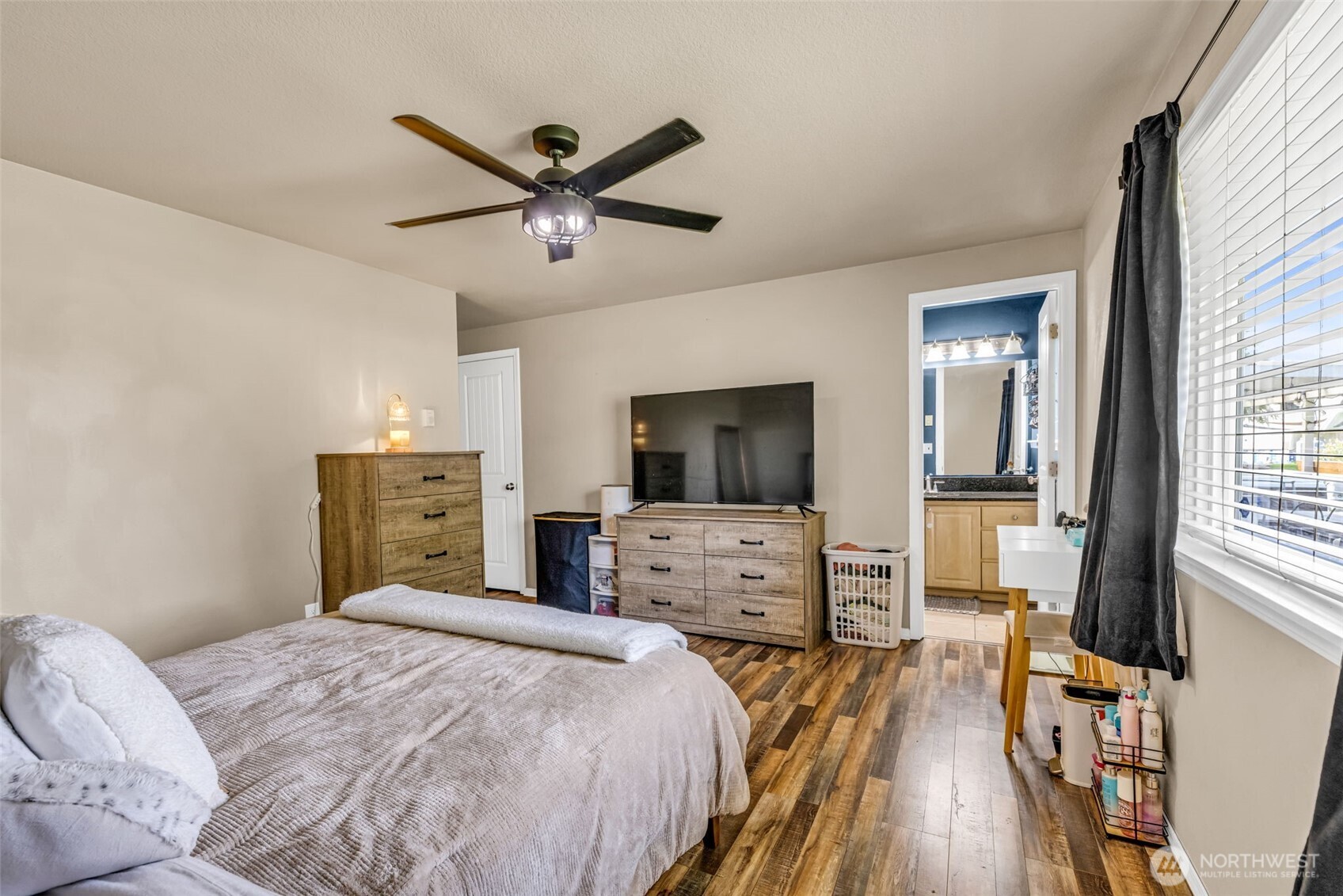 10313 School Land Road Southwest Rochester, WA 98579 - Photo 23 of 40 a bedroom with a bed and a flat screen tv