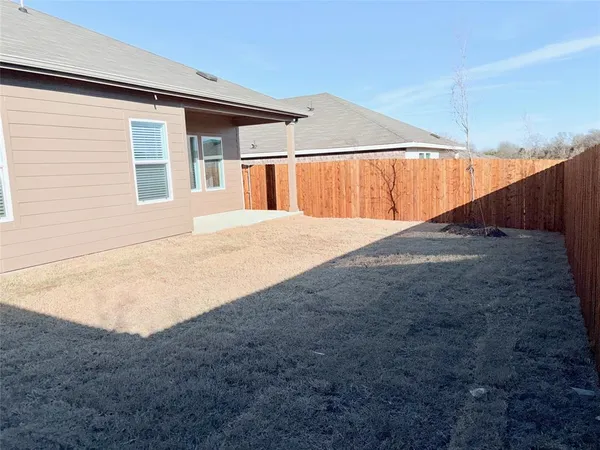 a view of a backyard of the house