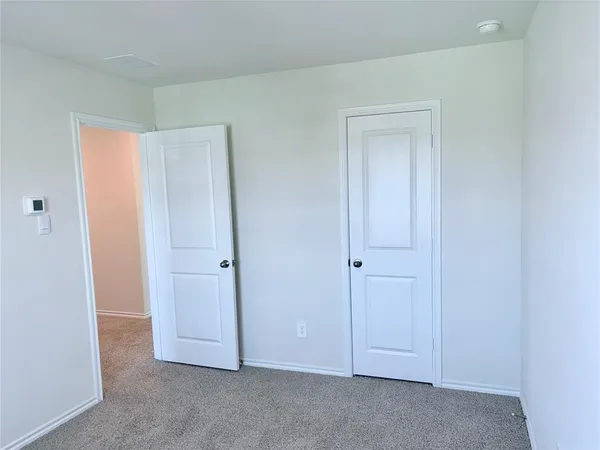 an empty room with closet area