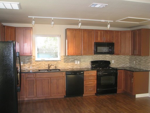 4511 Depew Avenue, Unit B Austin, TX 78751 - Photo 1 of 1 a kitchen with stainless steel appliances granite countertop a stove a sink dishwasher and a microwave oven with wooden floor