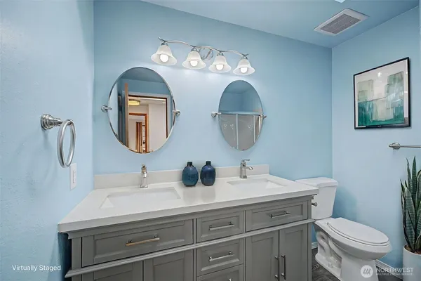 a bathroom with a toilet a sink and a mirror