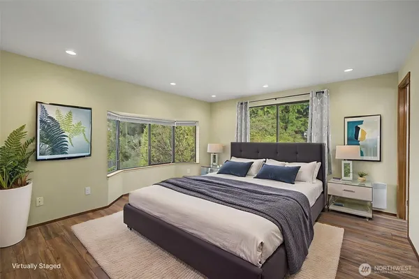 a bedroom with a large bed and a window