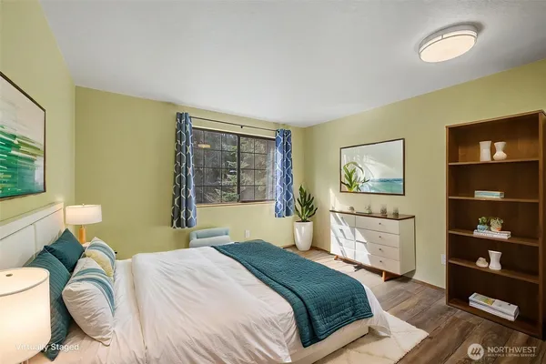 a bedroom with a bed and dresser