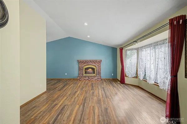 a view of a room with wooden floor closet and a window