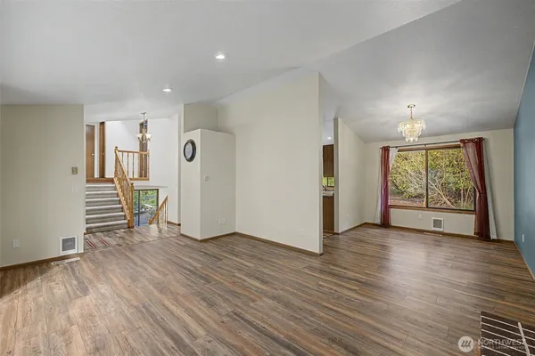 an empty room with wooden floor and a window